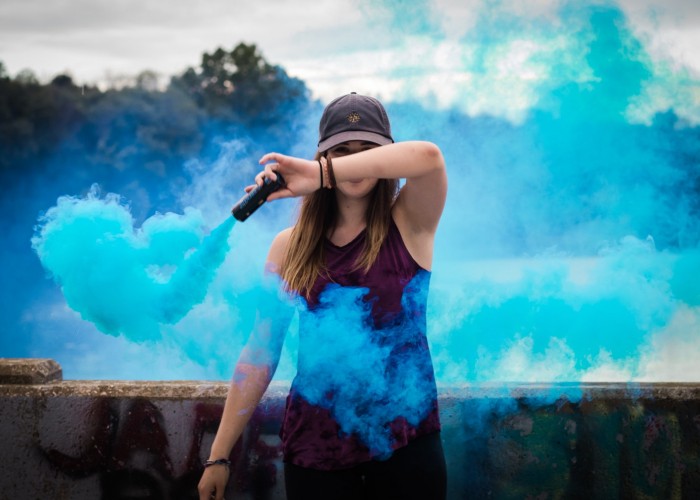 Woman Holding Blue Smoke Flare