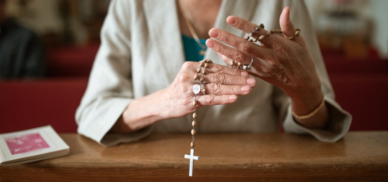 Close-Up Shot of a Person Holding Prayer Beads
