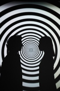 Silhouette of 2 People Standing in Front of Round White and Black Stripe Wall