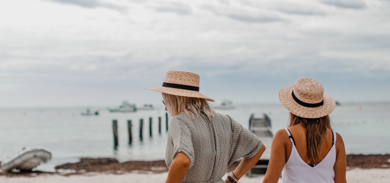 Women Wearing Sun Hat Standing on the Shore of a Beach
