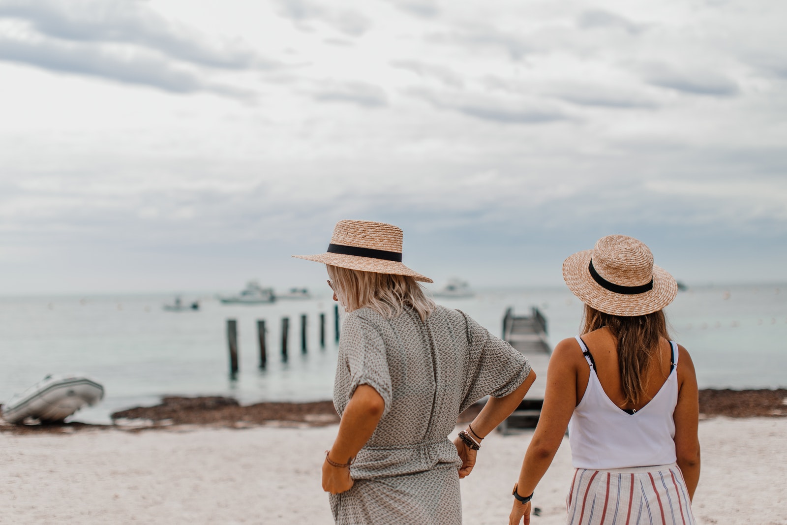 Women Wearing Sun Hat Standing on the Shore of a Beach