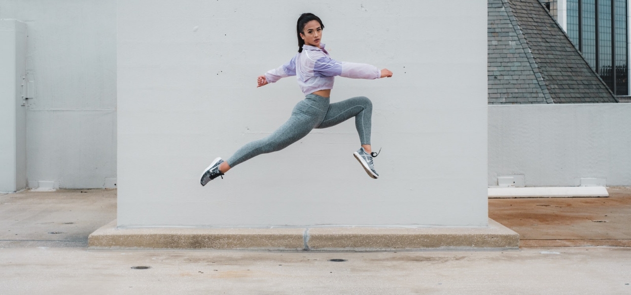 A Jump Shot of a Woman Wearing Activewear