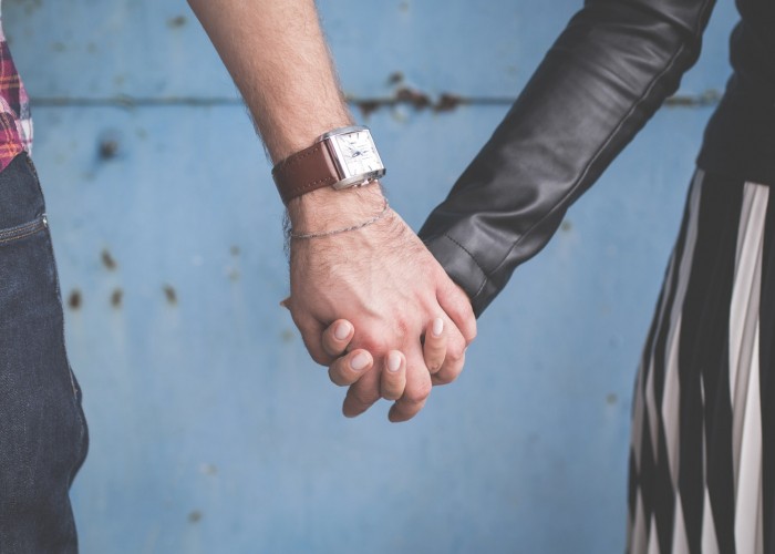 man and woman holding hands